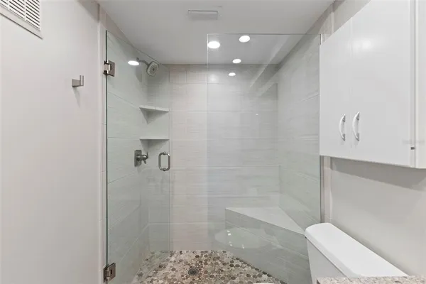 a view of an empty room with cabinet and a window