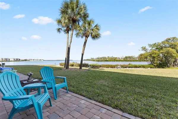 a swimming pool with outdoor seating and garden