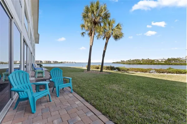 a view of a porch with furniture and garden