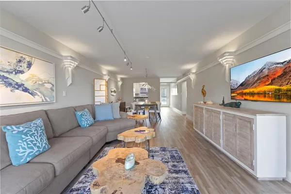 a view of a dining room with furniture and wooden floor