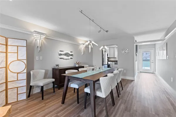 a view of a dining room with furniture window and wooden floor