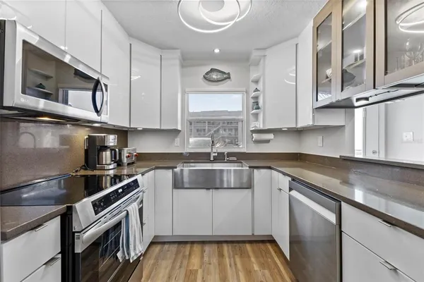 a kitchen with stainless steel appliances granite countertop a sink and a granite counter tops