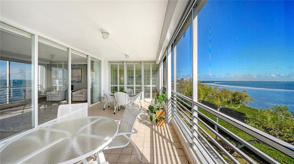 2410 Harbourside Drive, Unit 142 Longboat Key, FL 34228 - Photo 14 of 55 a balcony with chairs and wooden floor