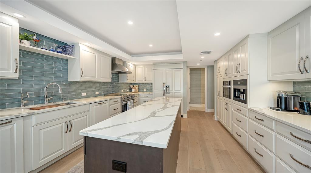 2410 Harbourside Drive, Unit 142 Longboat Key, FL 34228 - Photo 17 of 55 a large kitchen with cabinets stainless steel appliances a sink and a counter top space