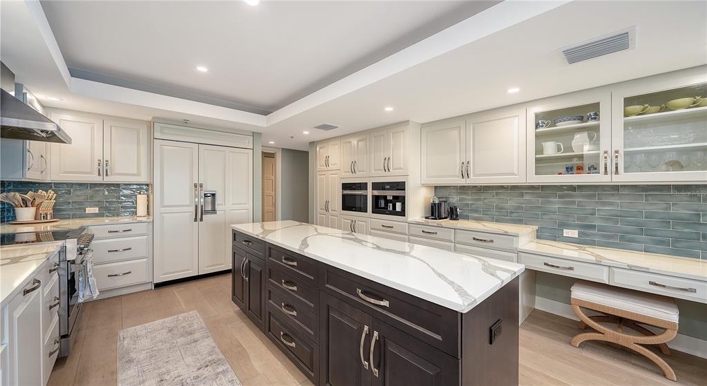 2410 Harbourside Drive, Unit 142 Longboat Key, FL 34228 - Photo 18 of 55 a kitchen with a stove sink and cabinets