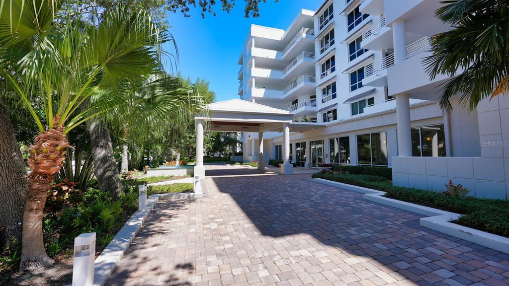 2410 Harbourside Drive, Unit 142 Longboat Key, FL 34228 - Photo 2 of 55 a view of a building with a garden
