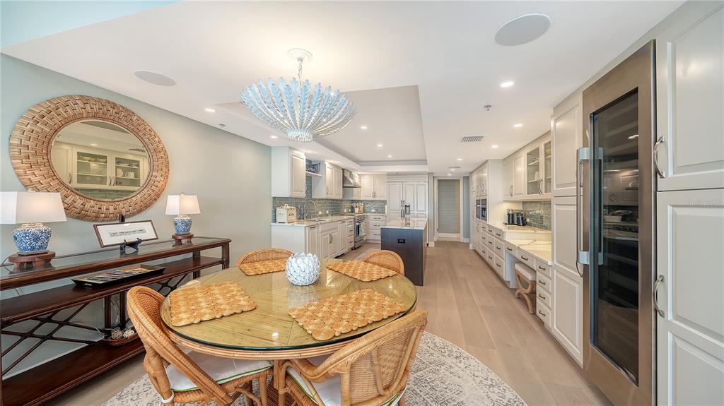 2410 Harbourside Drive, Unit 142 Longboat Key, FL 34228 - Photo 21 of 55 a large kitchen with a table and chairs