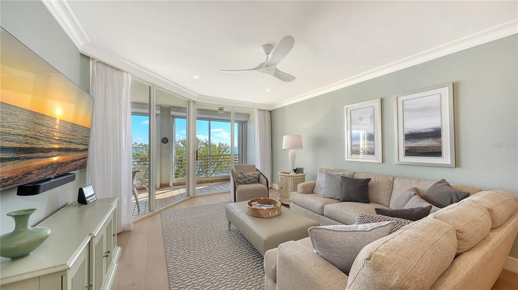 2410 Harbourside Drive, Unit 142 Longboat Key, FL 34228 - Photo 23 of 55 a living room with furniture and a flat screen tv