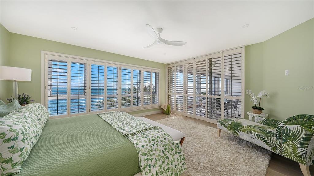 2410 Harbourside Drive, Unit 142 Longboat Key, FL 34228 - Photo 26 of 55 a bedroom with a bed and a large window