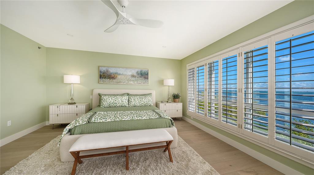 2410 Harbourside Drive, Unit 142 Longboat Key, FL 34228 - Photo 28 of 55 a bed sitting in a bedroom next to a window