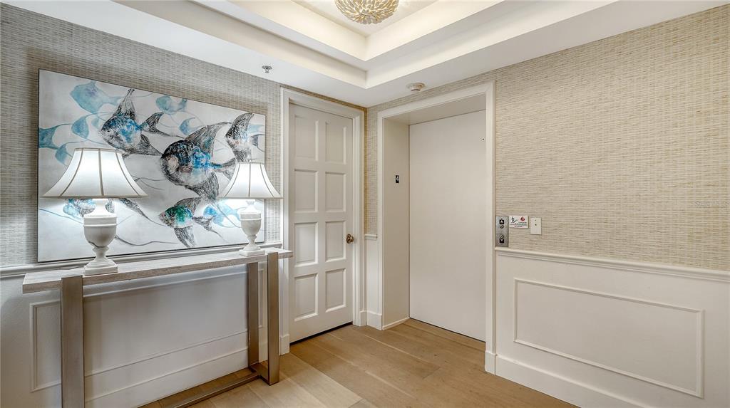 2410 Harbourside Drive, Unit 142 Longboat Key, FL 34228 - Photo 3 of 55 a view of a hallway and closet with wooden floor