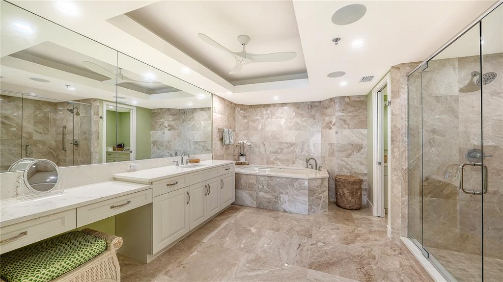 2410 Harbourside Drive, Unit 142 Longboat Key, FL 34228 - Photo 31 of 55 a spacious bathroom with a granite countertop sink mirror and shower