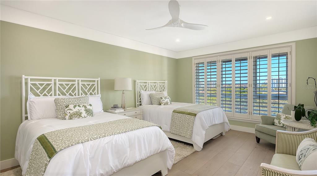 2410 Harbourside Drive, Unit 142 Longboat Key, FL 34228 - Photo 32 of 55 a bedroom with a bed and a couch
