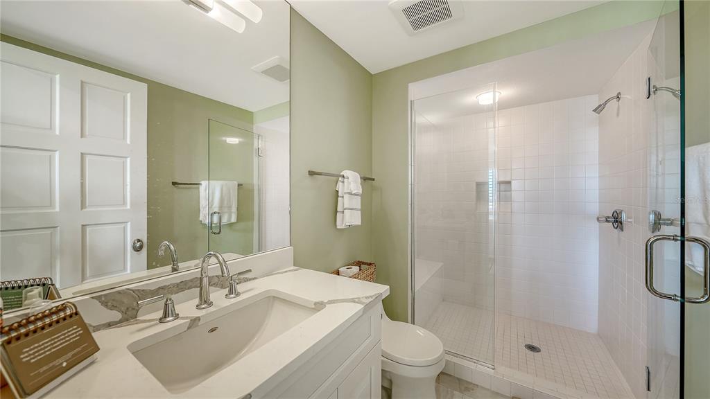 2410 Harbourside Drive, Unit 142 Longboat Key, FL 34228 - Photo 34 of 55 a bathroom with a sink toilet and shower