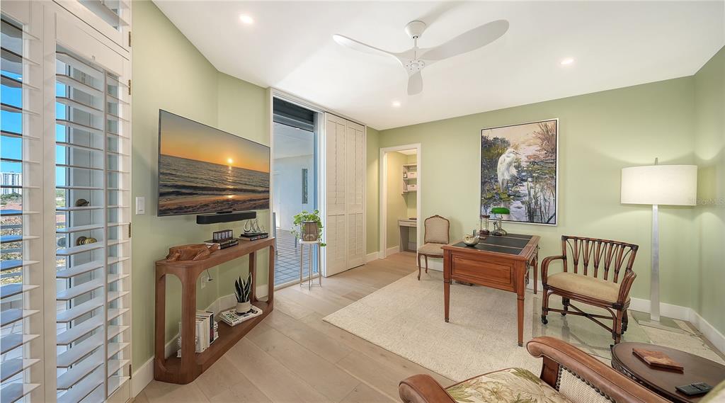 2410 Harbourside Drive, Unit 142 Longboat Key, FL 34228 - Photo 36 of 55 a living room with furniture a flat screen tv and a window