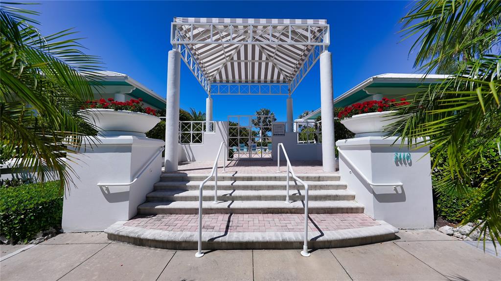 2410 Harbourside Drive, Unit 142 Longboat Key, FL 34228 - Photo 43 of 55 a view of a patio with table and chairs and potted plants