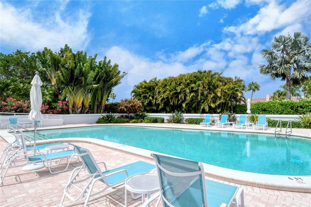 2410 Harbourside Drive, Unit 142 Longboat Key, FL 34228 - Photo 44 of 55 a view of a swimming pool and lounge chairs