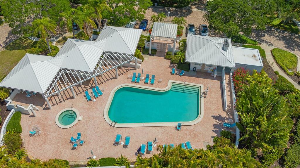 2410 Harbourside Drive, Unit 142 Longboat Key, FL 34228 - Photo 48 of 55 an aerial view of a house with a swimming pool and outdoor seating