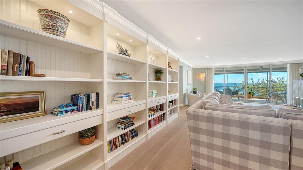 2410 Harbourside Drive, Unit 142 Longboat Key, FL 34228 - Photo 8 of 55 a room with furniture and a book shelf