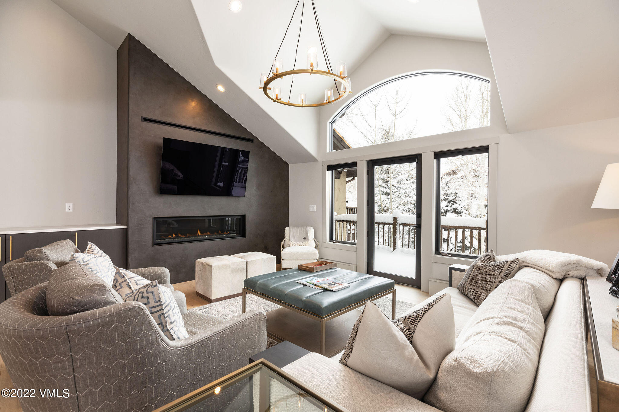 92 Knudson Ranch Road Edwards, CO 81632 - Photo 3 of 21 a living room with furniture a chandelier and a flat screen tv