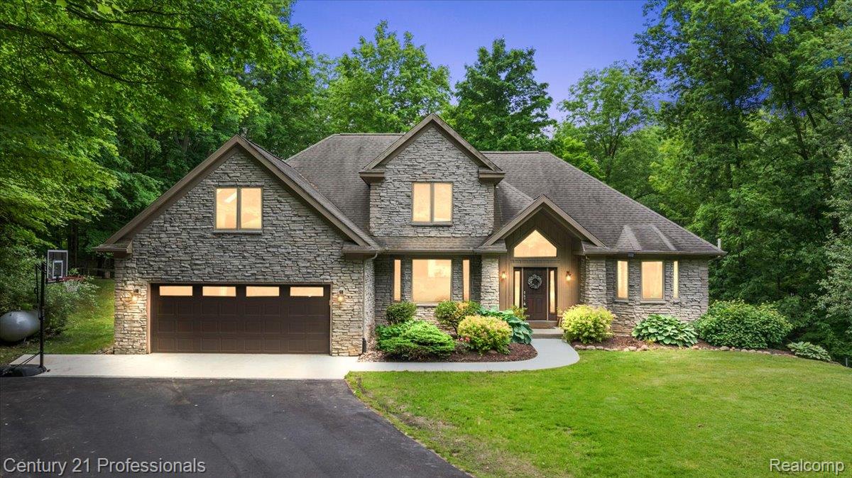 9867 Rainbow Ridge Drive Schoolcraft, MI 49087 - Photo 78 of 82 Stone veneer exterior with a gabled roofline and an attached two-car garage