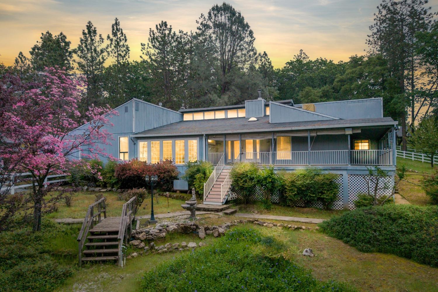 25445 Table Meadow Road Auburn, CA 95602 - Photo 1 of 1 a front view of a house with a yard table and chairs