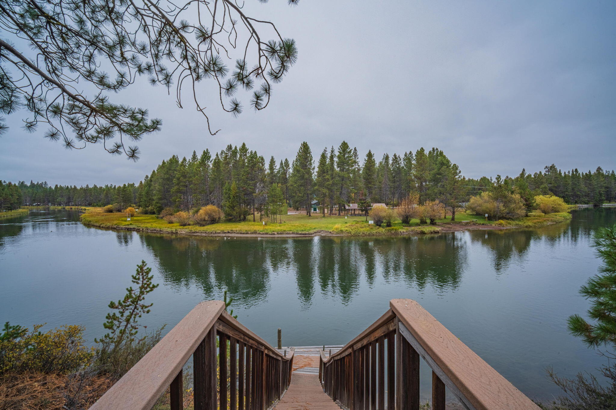 56019 Snow Goose Road Bend, OR 97707 - Photo 6 of 32 a view of a lake with a house in the background