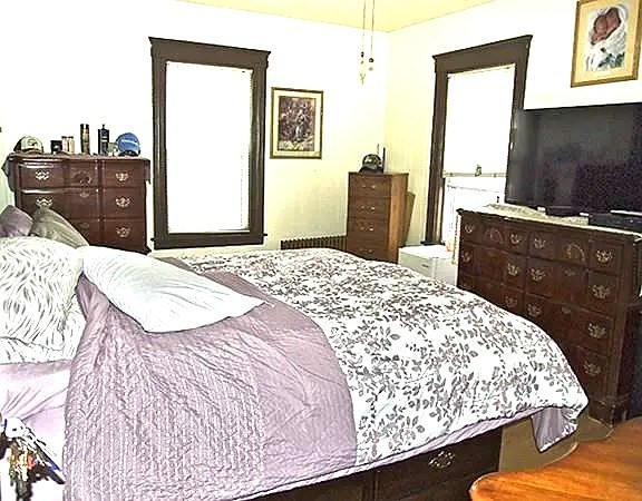 56 Plantation Street Worcester, MA 01604 - Photo 11 of 18 a bedroom with a bed and a dresser