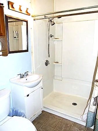 56 Plantation Street Worcester, MA 01604 - Photo 18 of 18 a bathroom with a sink a mirror and a shower