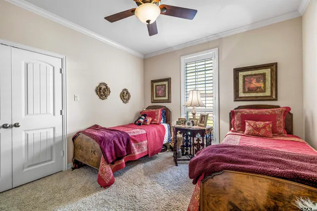 a bedroom with two beds and a chandelier