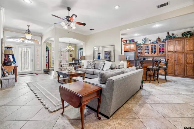a living room with furniture and kitchen view