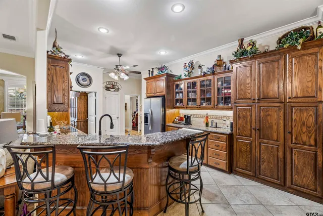 a kitchen with stainless steel appliances granite countertop a sink and a refrigerator