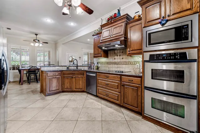a kitchen with stainless steel appliances granite countertop a stove and a microwave