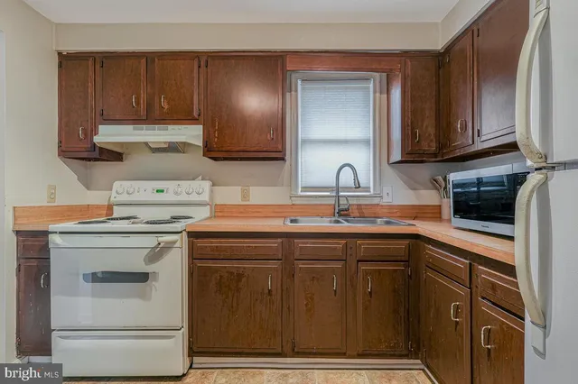 a kitchen with a sink cabinets and appliances