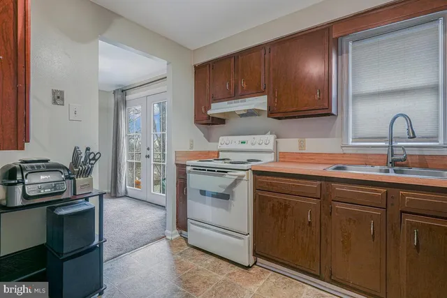 a kitchen with a sink stove and cabinets