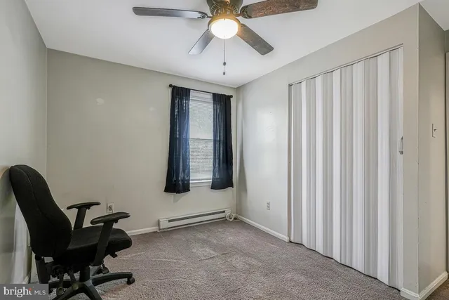 a workspace with chandelier and window