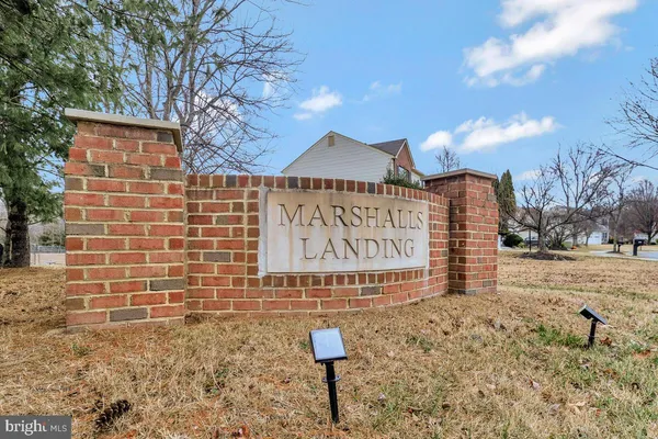 a sign board with building in the background