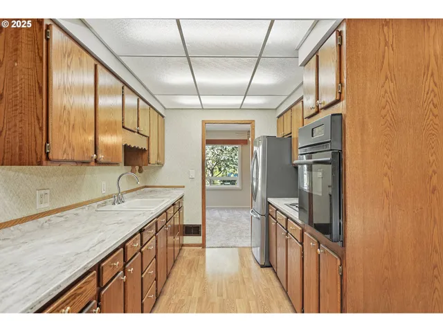 a kitchen with stainless steel appliances granite countertop a sink stove and cabinets