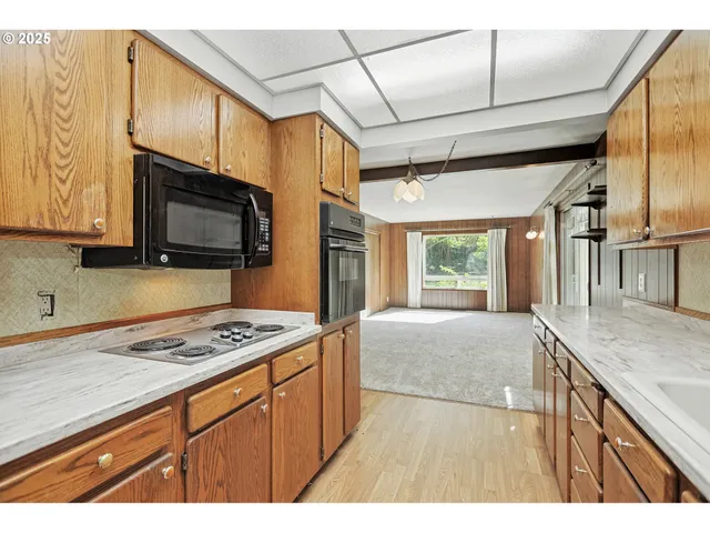 a kitchen with stainless steel appliances granite countertop a sink stove and microwave