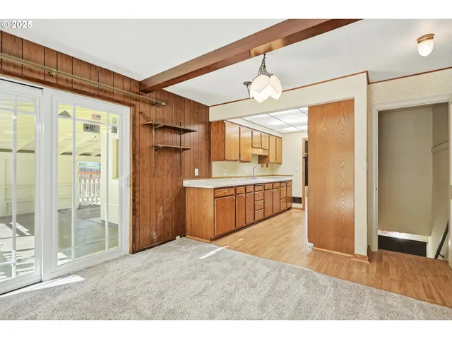 a kitchen with stainless steel appliances kitchen island granite countertop a refrigerator and a sink