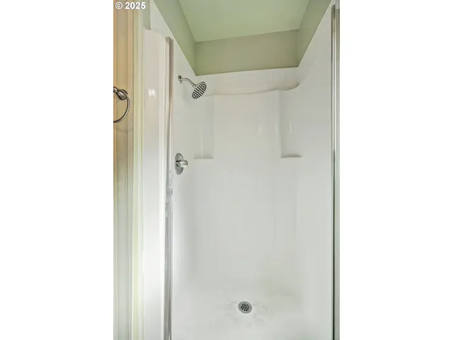 a bathroom with a glass door shower