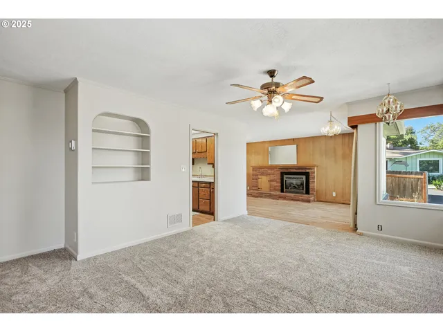 a view of a livingroom with a ceiling fan a flat screen tv and a ceiling fan