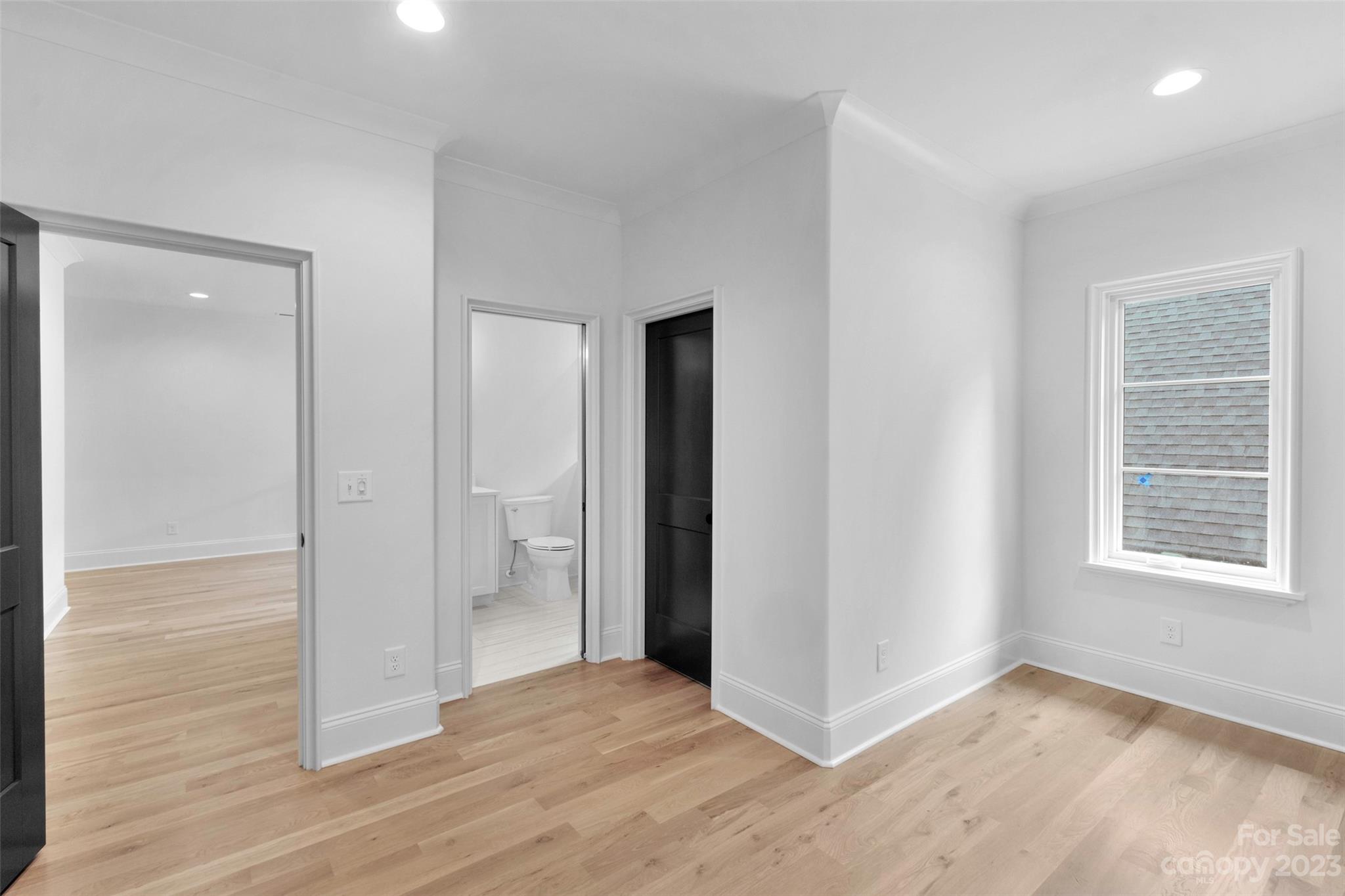 728 Ellsworth Road Charlotte, NC 28211 - Photo 26 of 43 a view of an empty room with wooden floor and a window