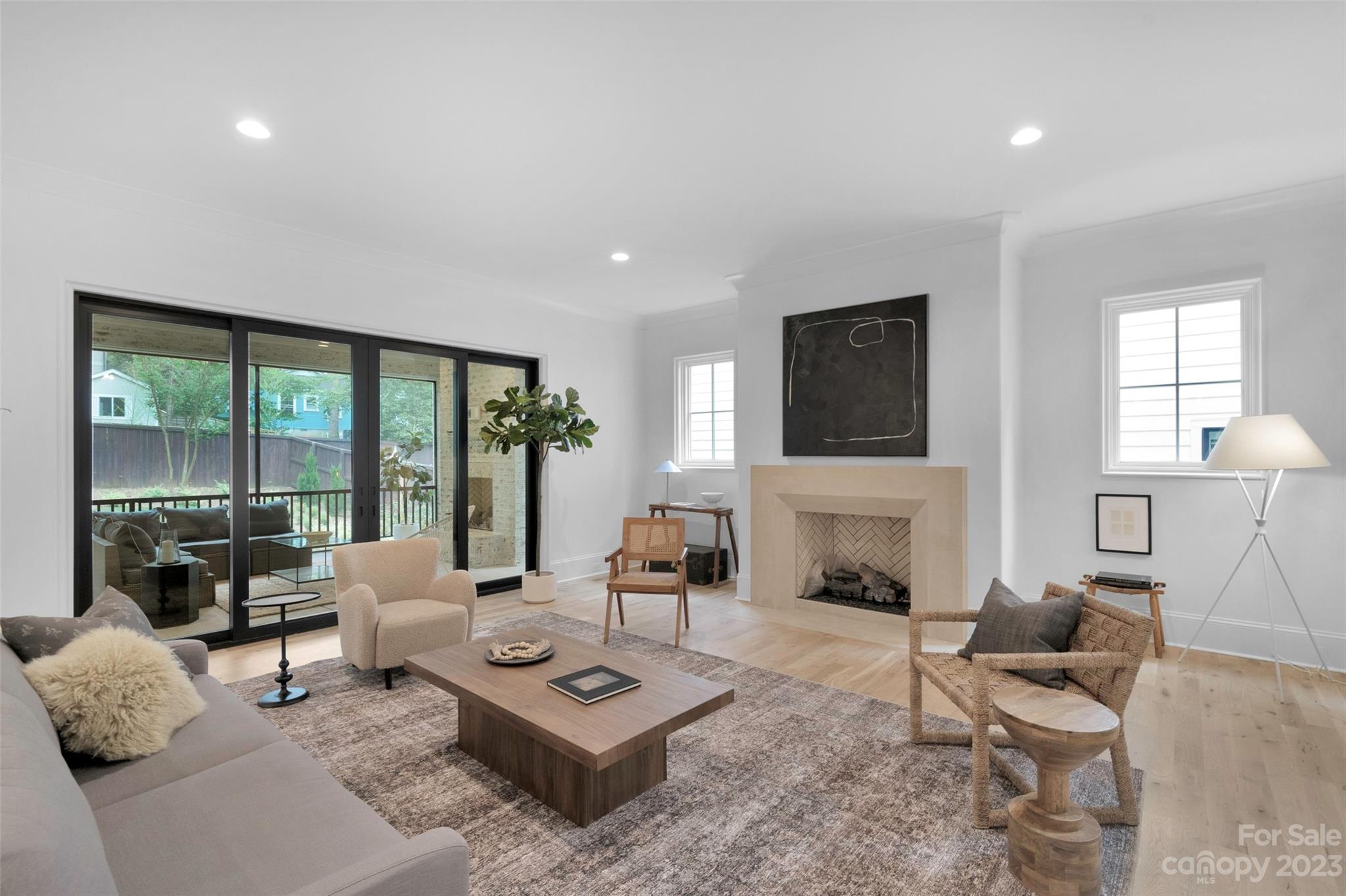 728 Ellsworth Road Charlotte, NC 28211 - Photo 6 of 43 a living room with furniture a fireplace and large windows