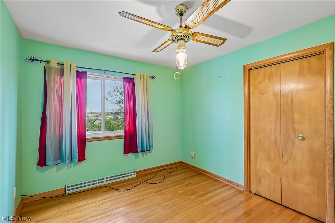 2060 6th Street Southwest Akron, OH 44314 - Photo 21 of 46 Bedroom with ceiling light / fan, closet and wood flooring