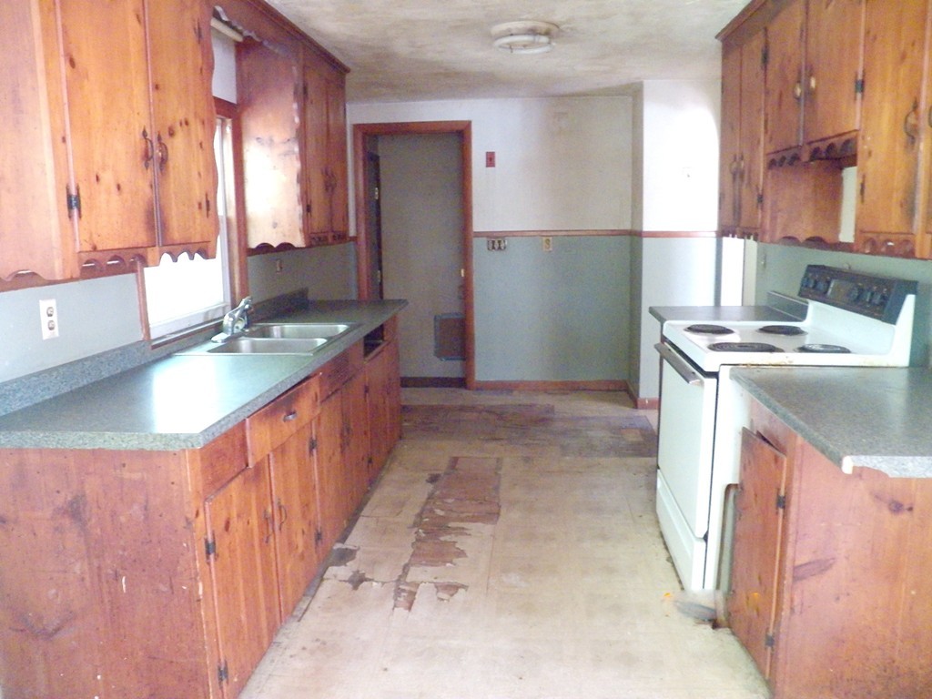 62 Parham Road Tyngsborough, MA 01879 - Photo 3 of 11 a kitchen with stainless steel appliances granite countertop a sink and a stove