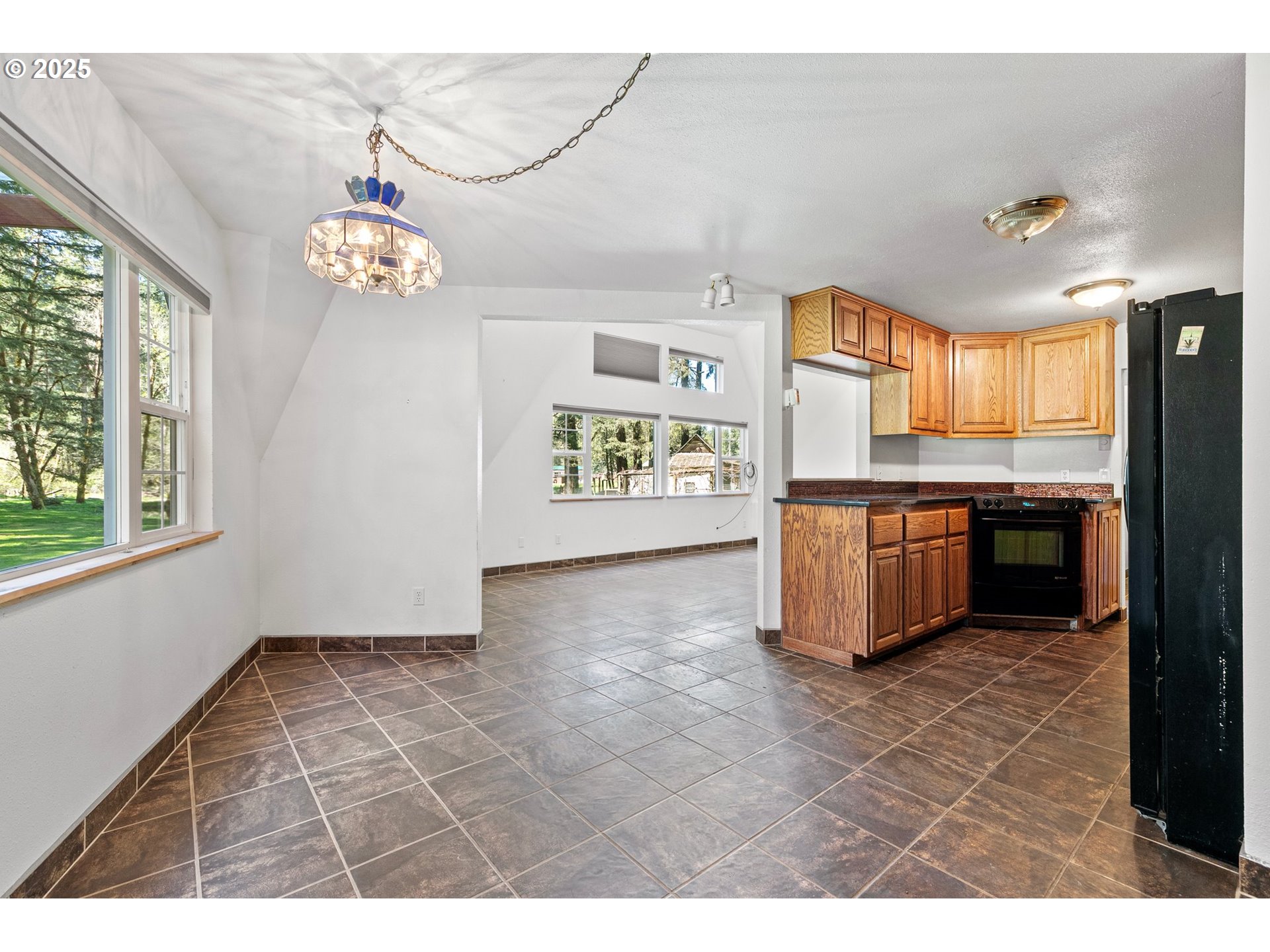 24458 Panther Creek Road Veneta, OR 97487 - Photo 15 of 46 a view of a kitchen with a sink cabinets and window