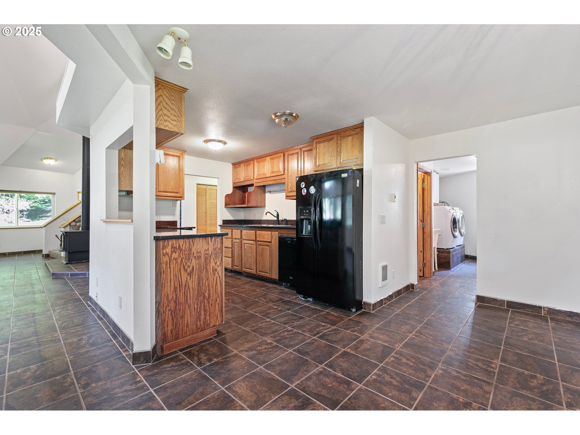 24458 Panther Creek Road Veneta, OR 97487 - Photo 17 of 46 a kitchen with stainless steel appliances kitchen island granite countertop a refrigerator and a sink