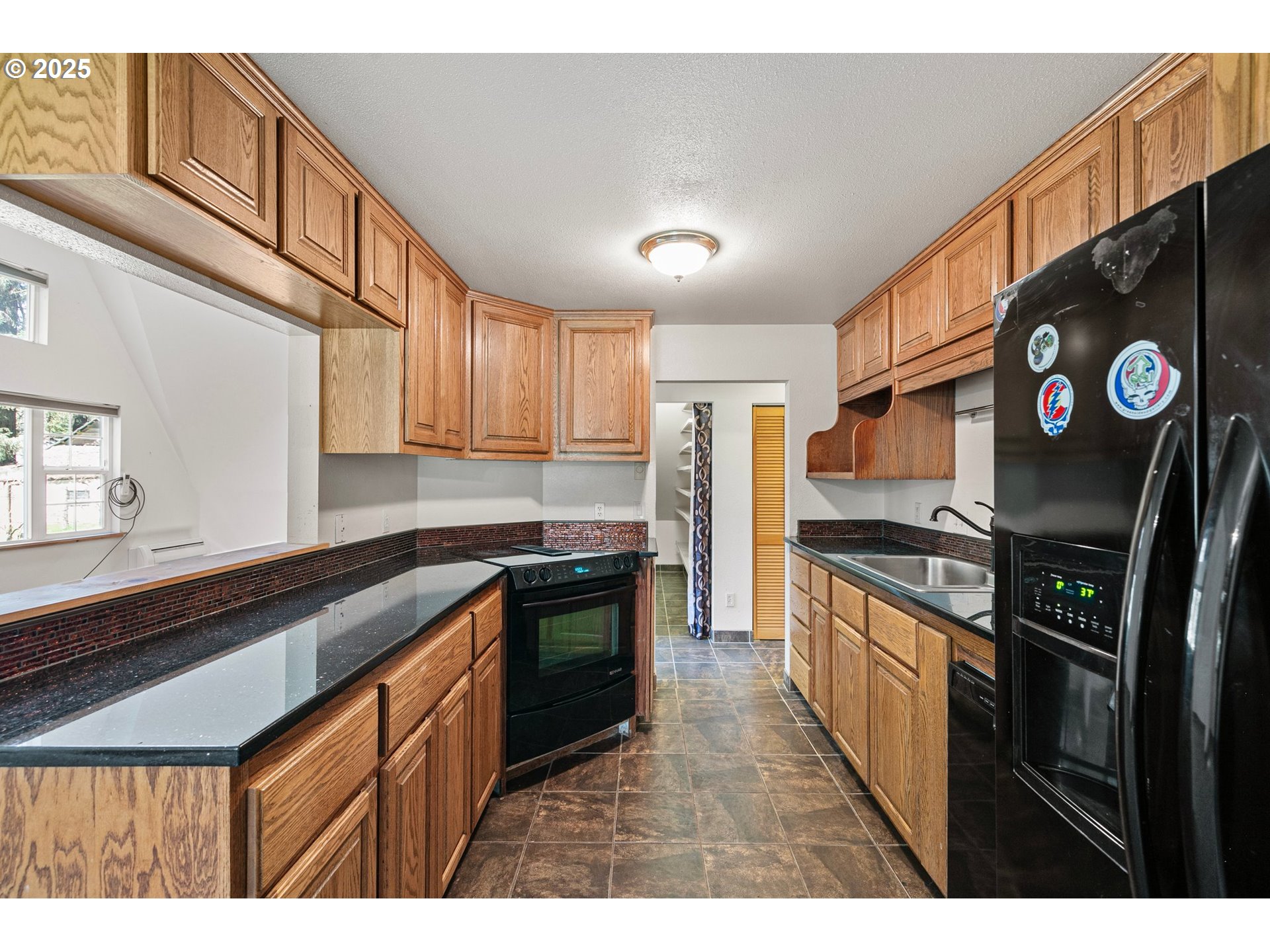 24458 Panther Creek Road Veneta, OR 97487 - Photo 18 of 46 a kitchen with stainless steel appliances granite countertop a stove a sink and a refrigerator