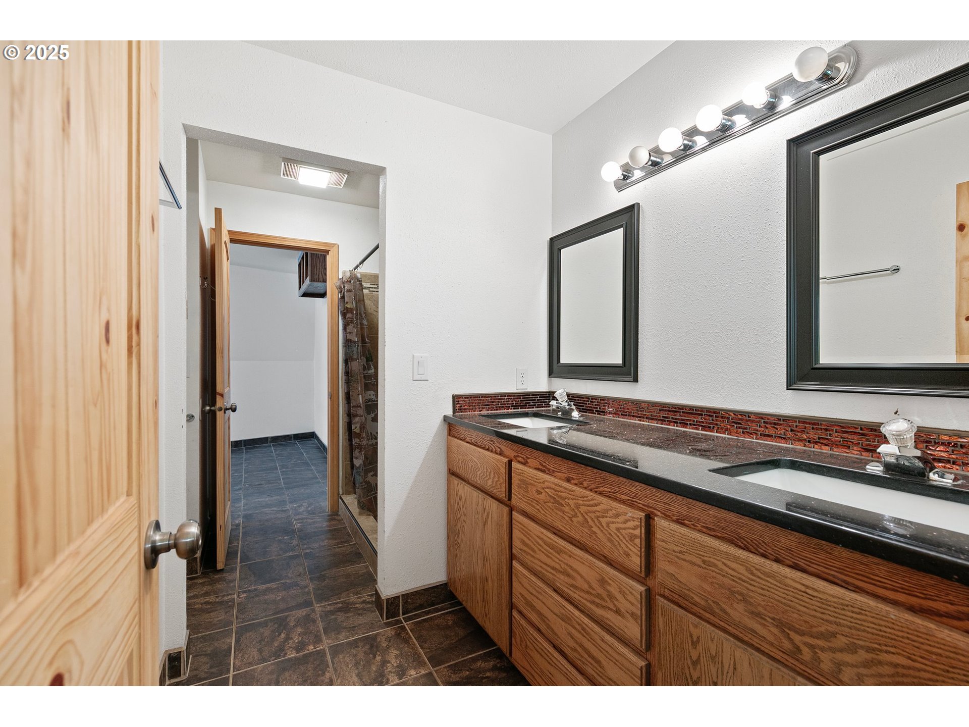 24458 Panther Creek Road Veneta, OR 97487 - Photo 24 of 46 a bathroom with a granite countertop sink and a mirror
